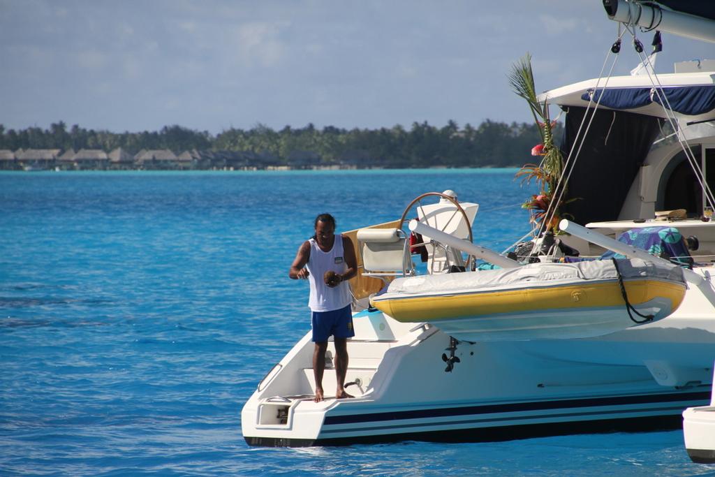 Cleaning freshly gathered clams in Bora Bora Lagoon - Sail Tahiti Yacht Rally © Maggie Joyce